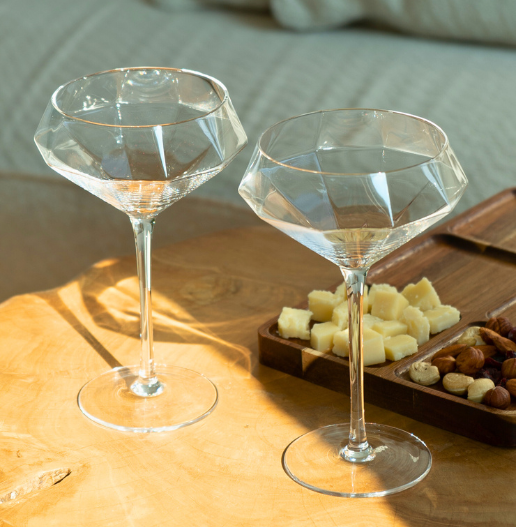 martini tall glasses standing on a coffee table warm light