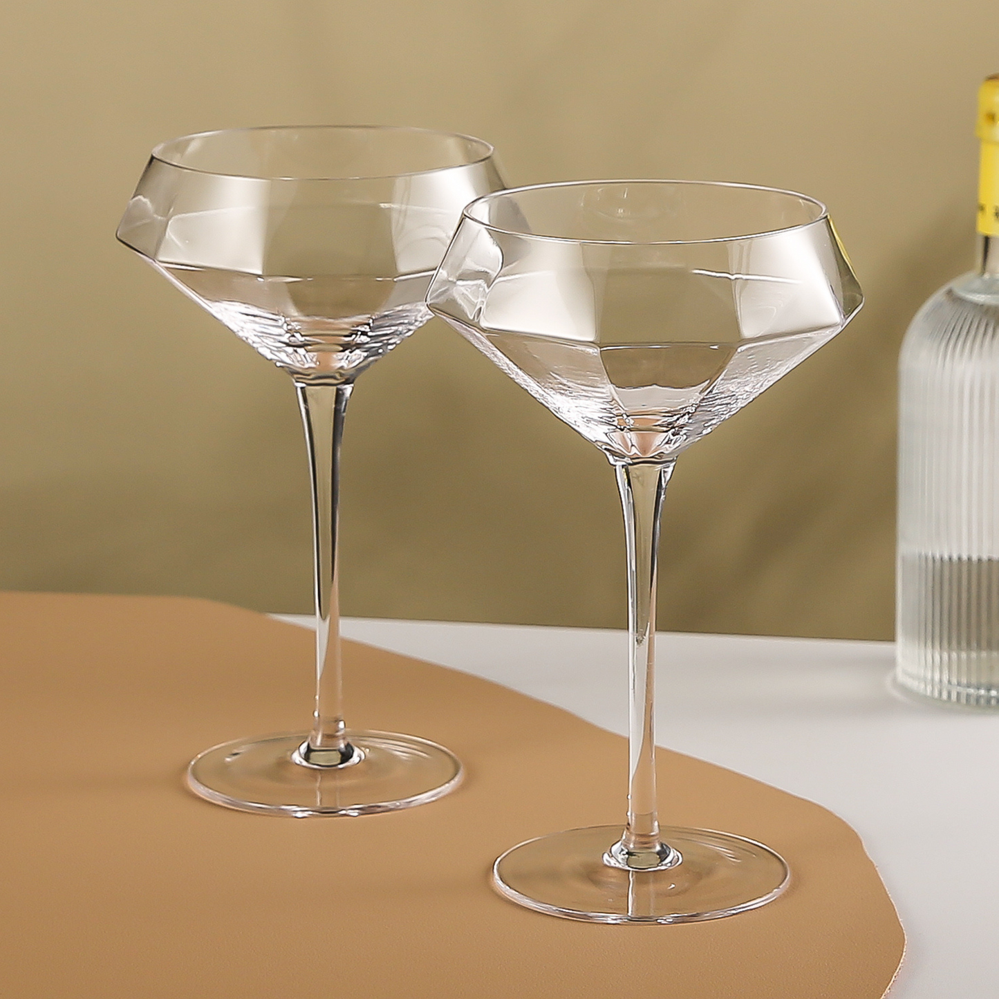 Empty martini glasses with diamond shape on neutral background
