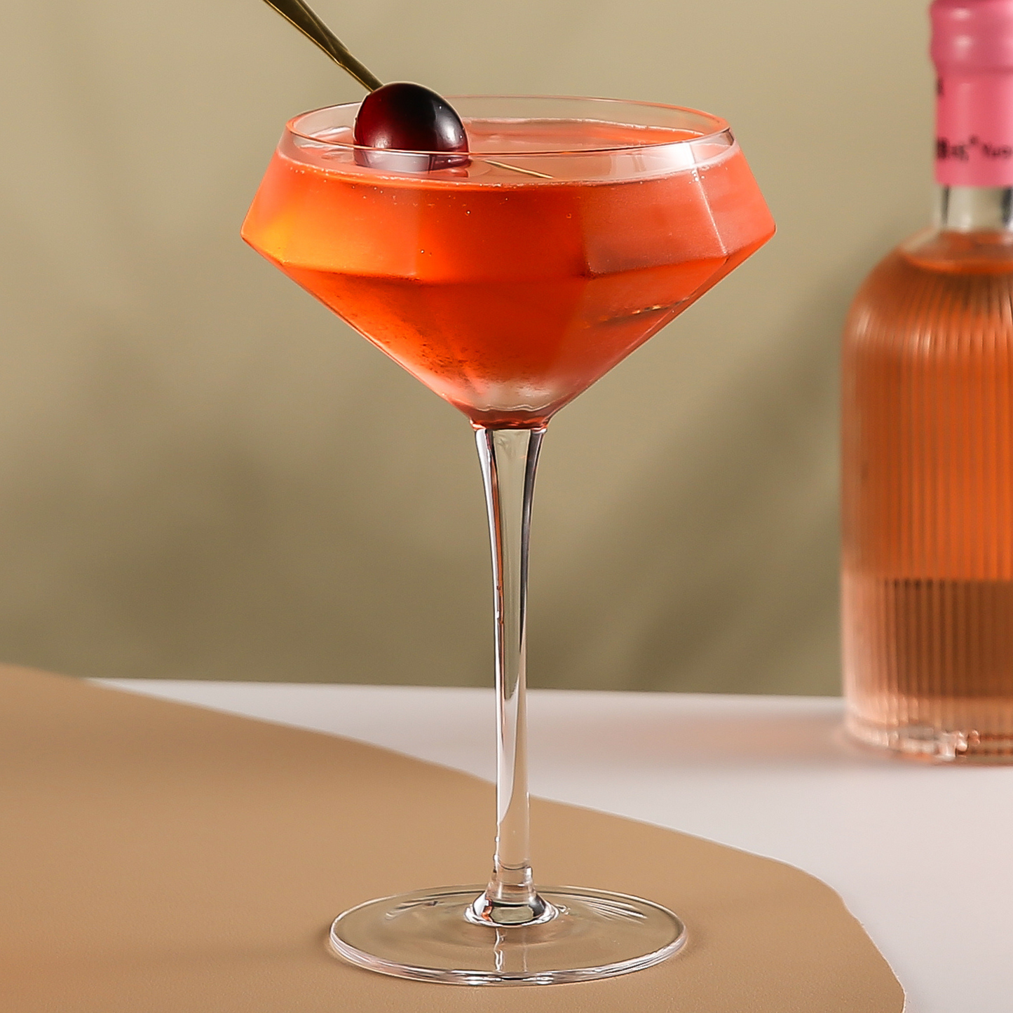 Stemmed martini glass filled with red cocktail