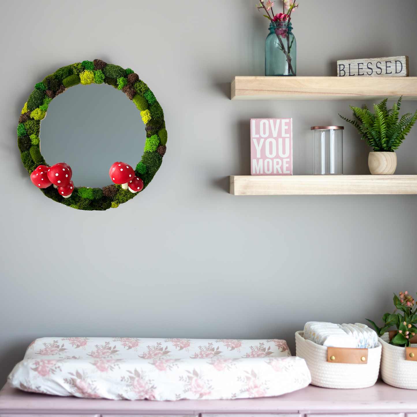 Nursery setup with changing table and soft decor – cute moss mirror for nursery wall decorations