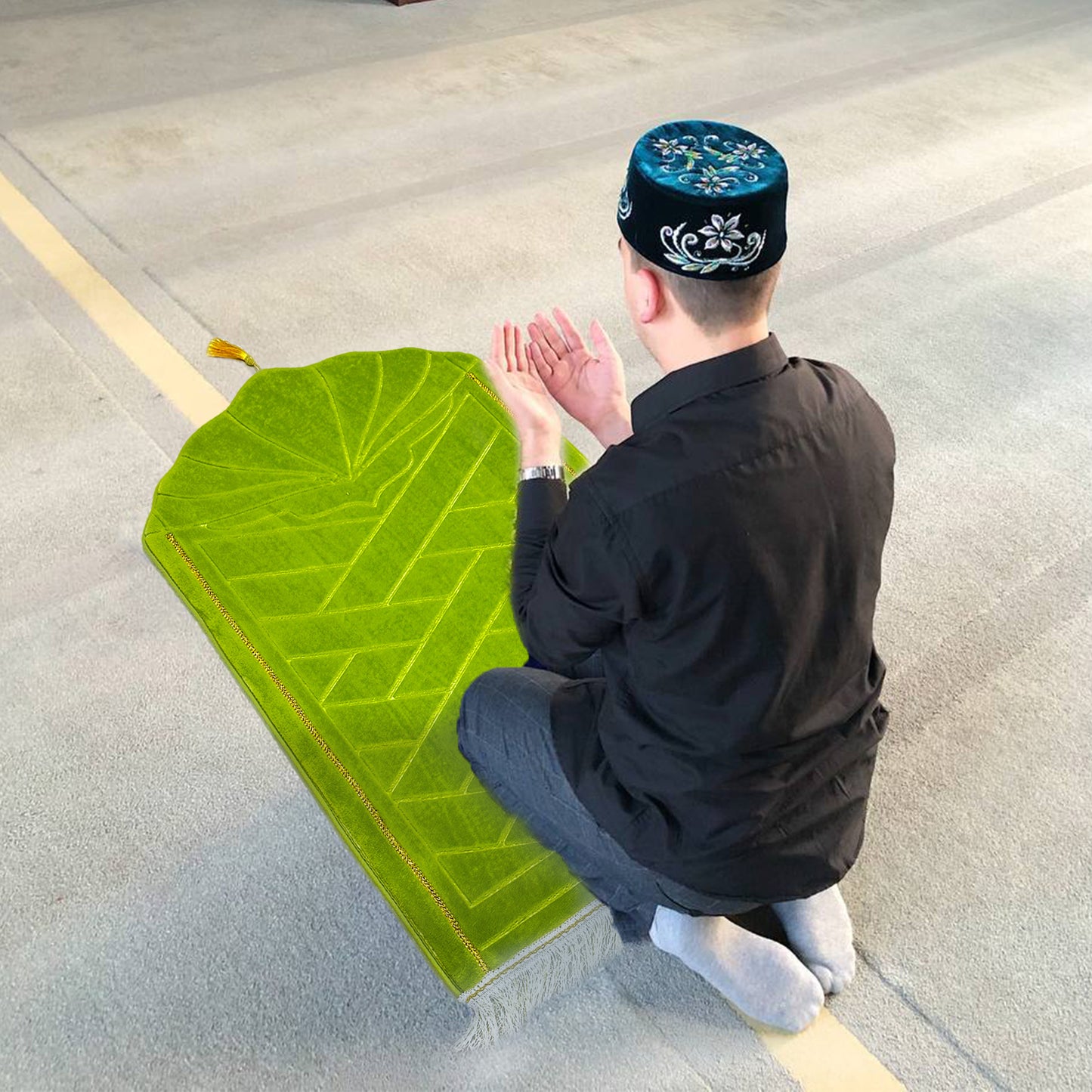 Muslim man praying on soft green prayer rug – ideal for daily prayer and Ramadan decorations