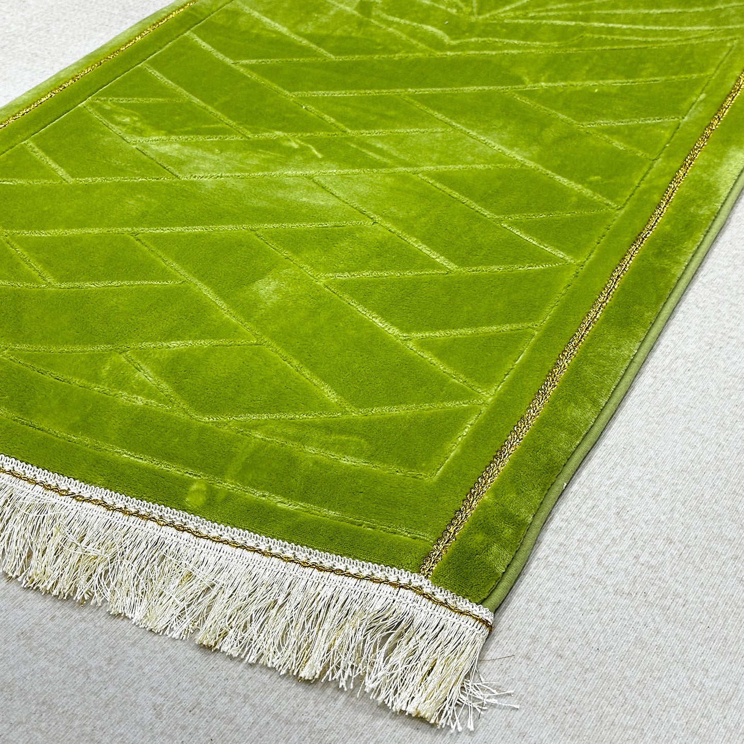 Fringed tassel trim of soft prayer rug – plush Islamic mat with decorative bottom edge