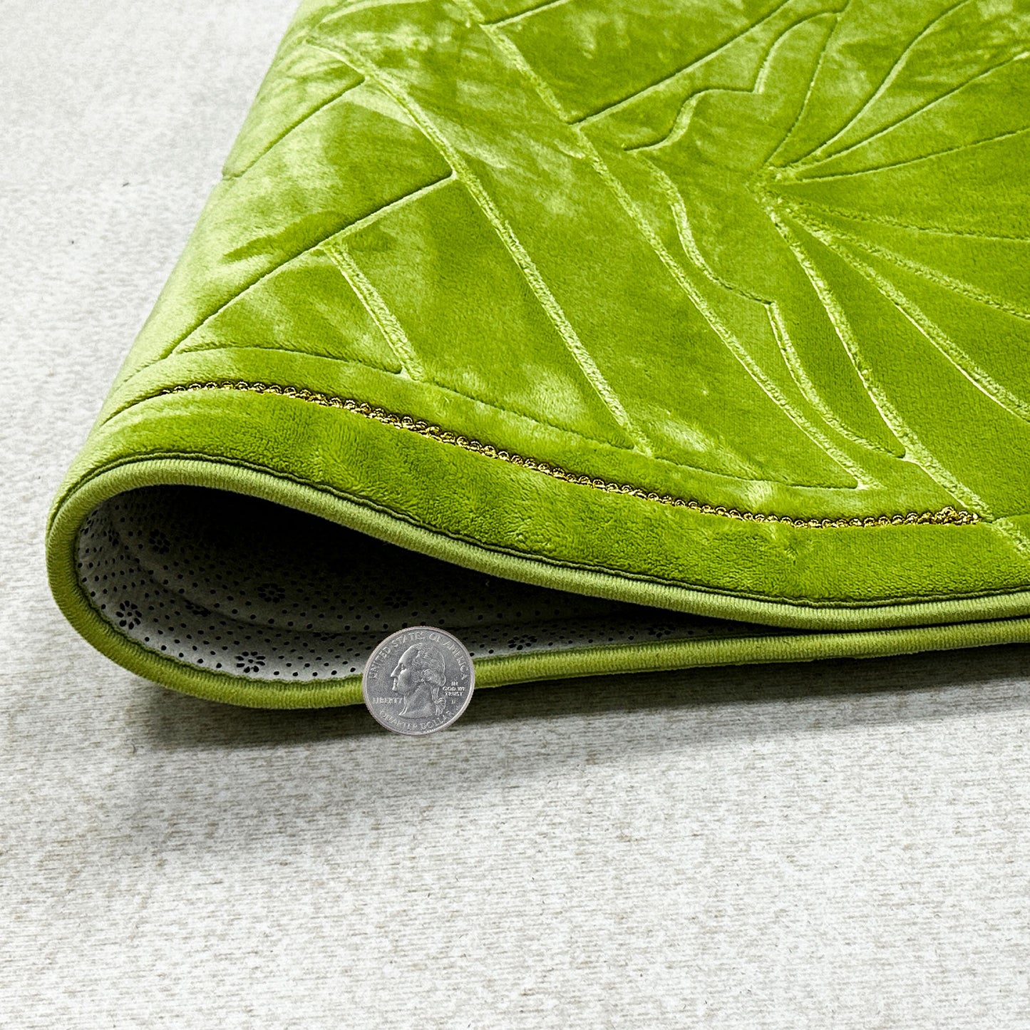 Thick padded green prayer mat – soft Islamic rug with plush feel, shown with coin for scale