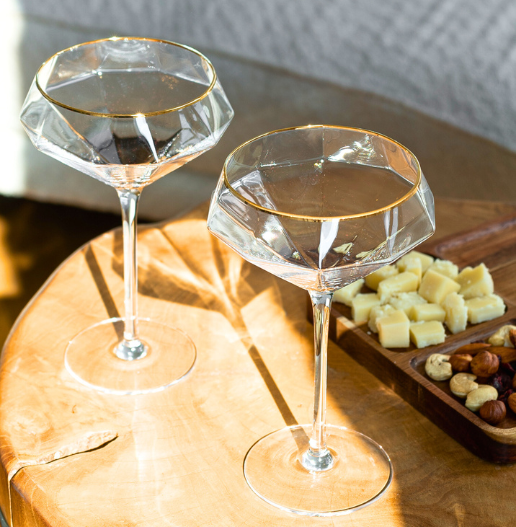 espresso martini glasses warm sunlight standing on a table with appetizers