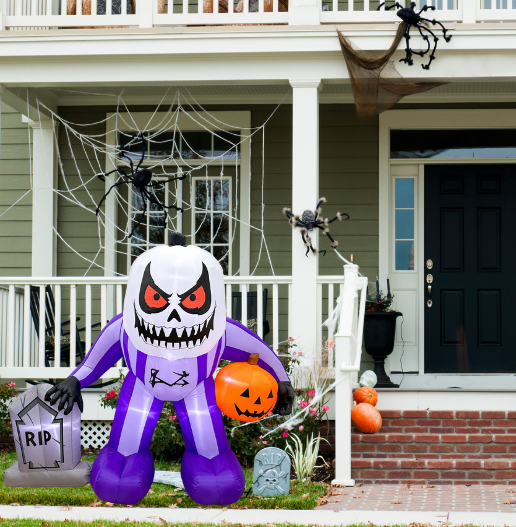 Mystic Moon Jack being set up with included ropes, stakes, and fan in outdoor Halloween yard scene