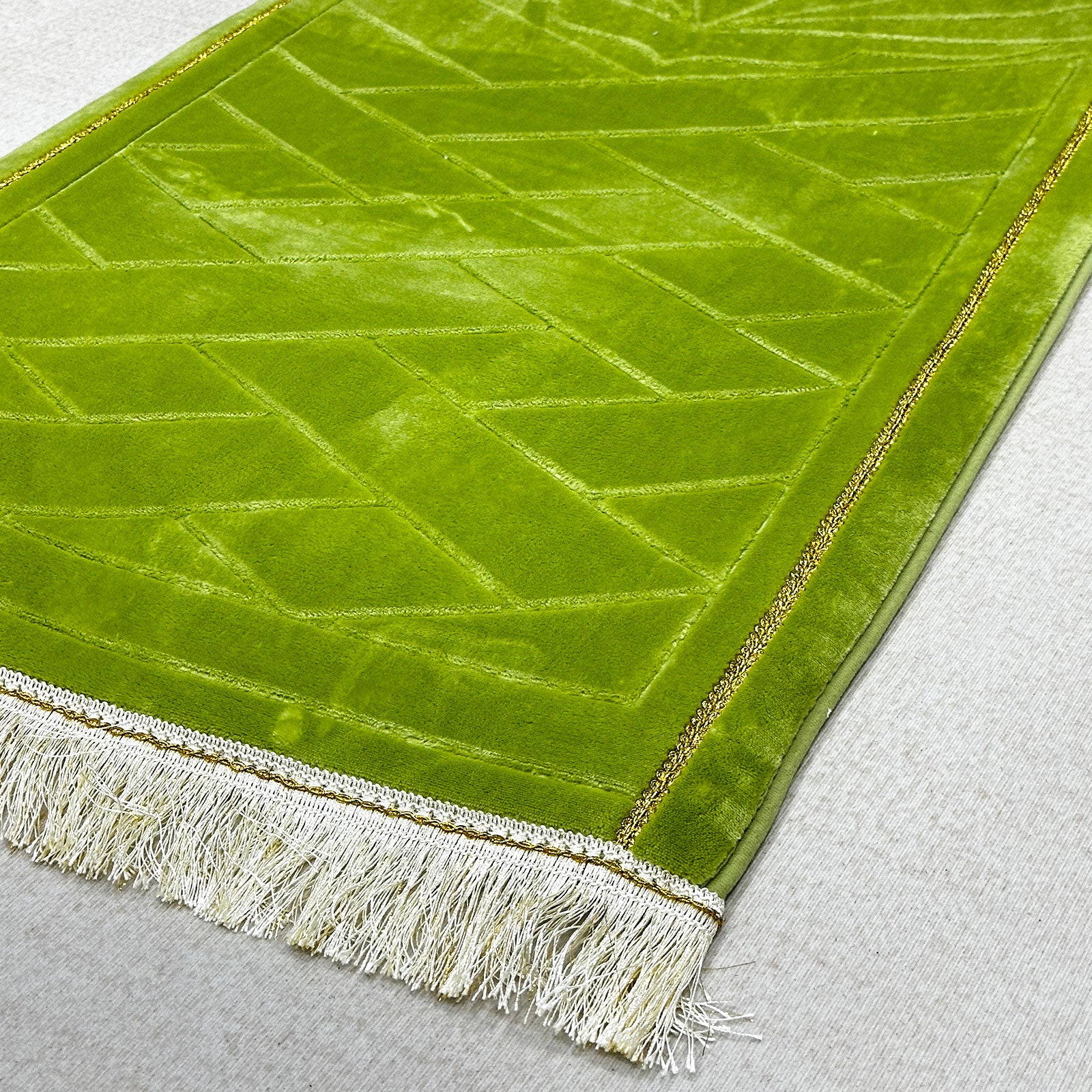 Fringed tassel trim of soft prayer rug – plush Islamic mat with decorative bottom edge
